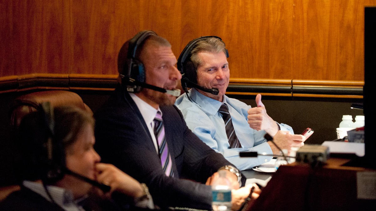 Vince McMahon and Triple H sitting in Gorilla Position