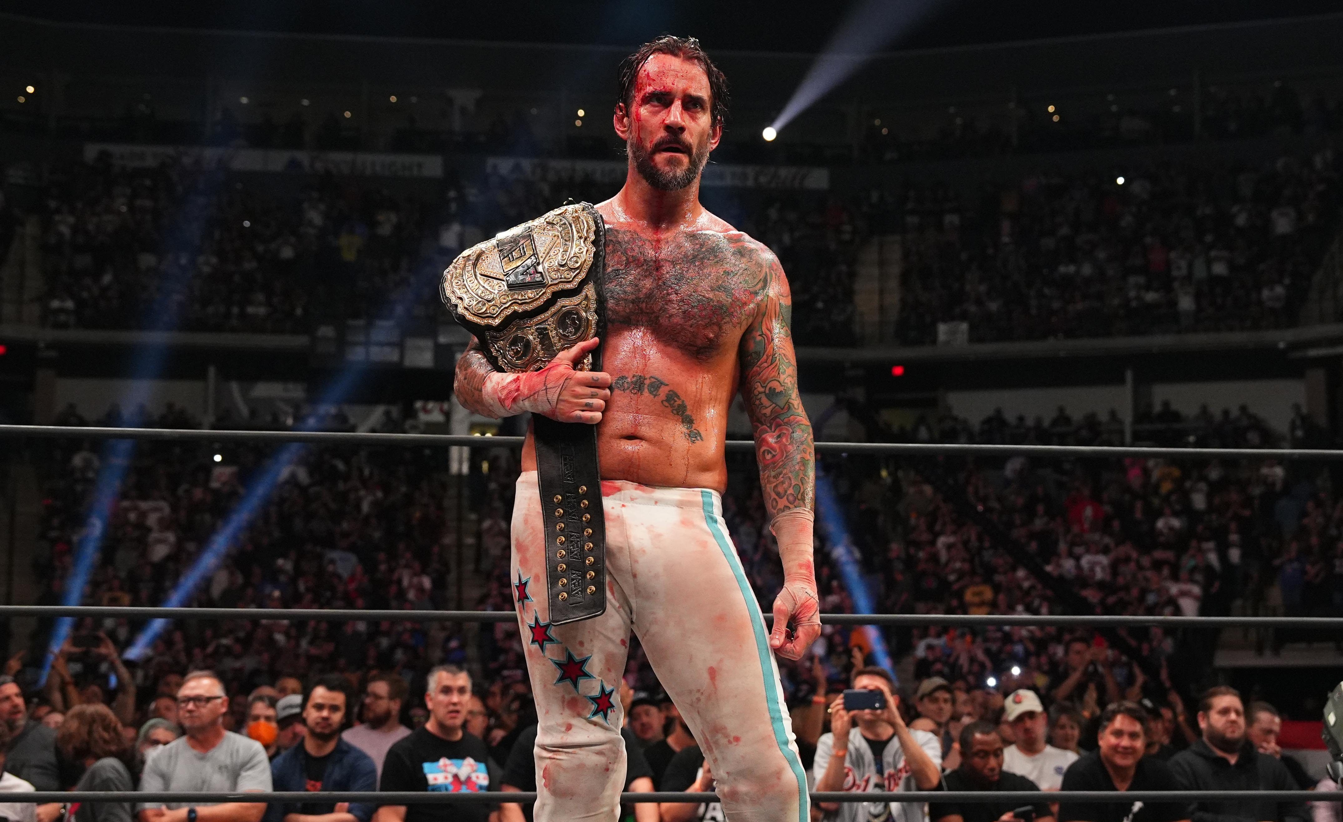 CM Punk celebrates as AEW World Champion at AEW All Out 2022