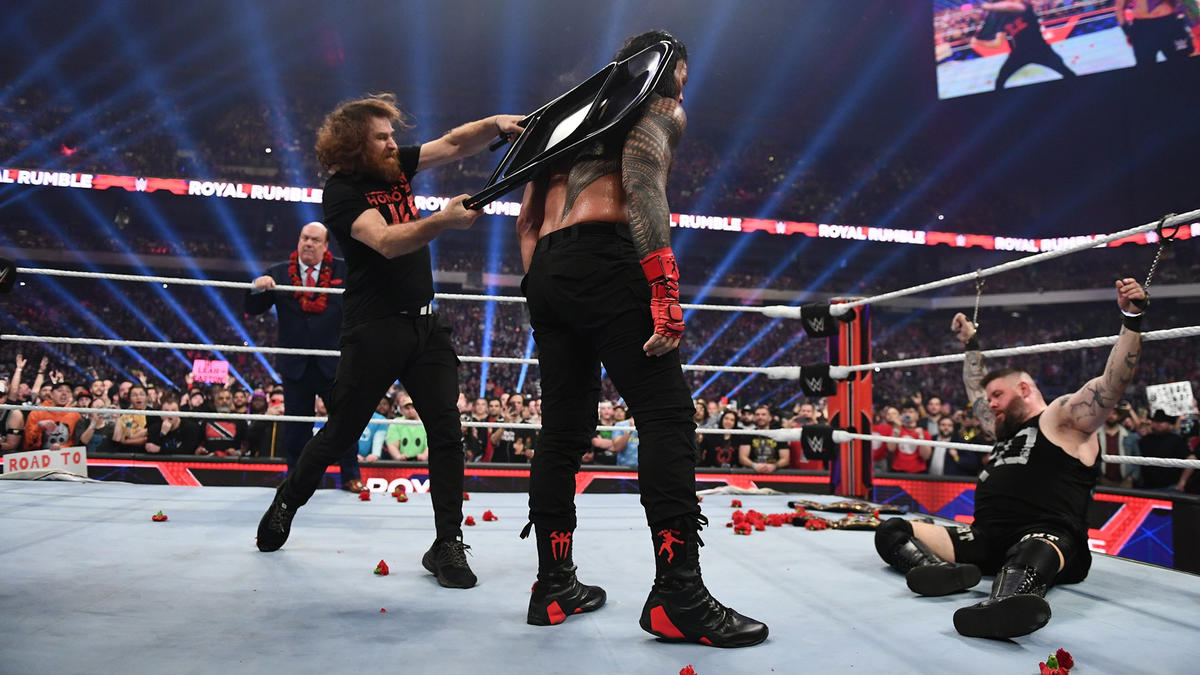 Sami Zayn hits Roman Reigns with chair