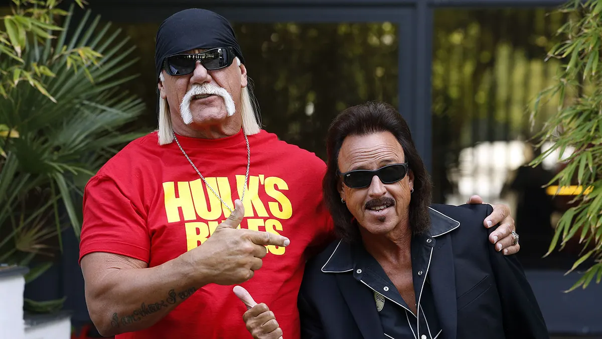 Hulk Hogan with his arm around Jimmy Hart