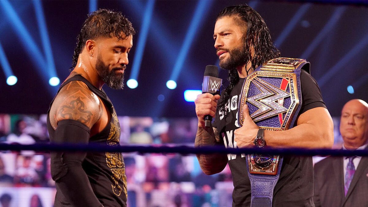 Roman Reigns speaking to Jey Uso in the ring.