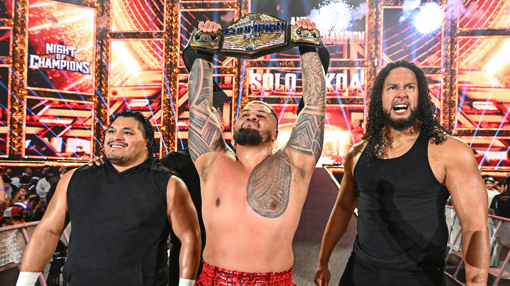 Solo Sikoa holding up WWE US Championship alongside JC Mateo and Talla Tonga