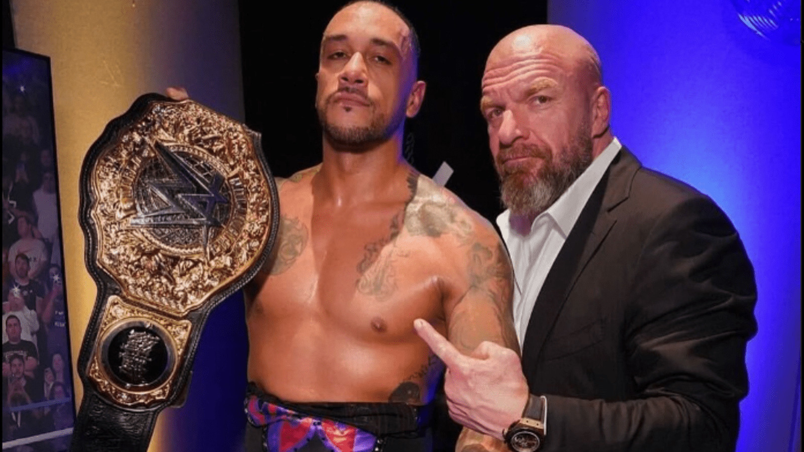 Triple H pointing at Damian Priest after winning WWE World Heavyweight Title