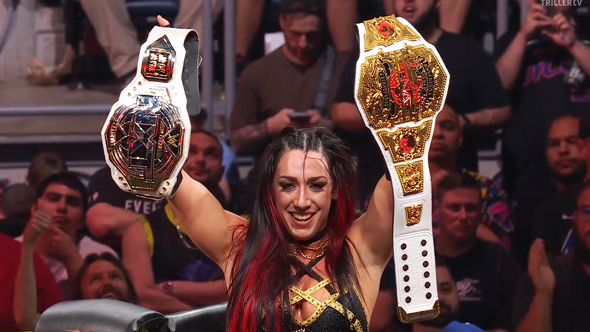 Jacy Jayne holding up NXT Women's and TNA Knockouts titles
