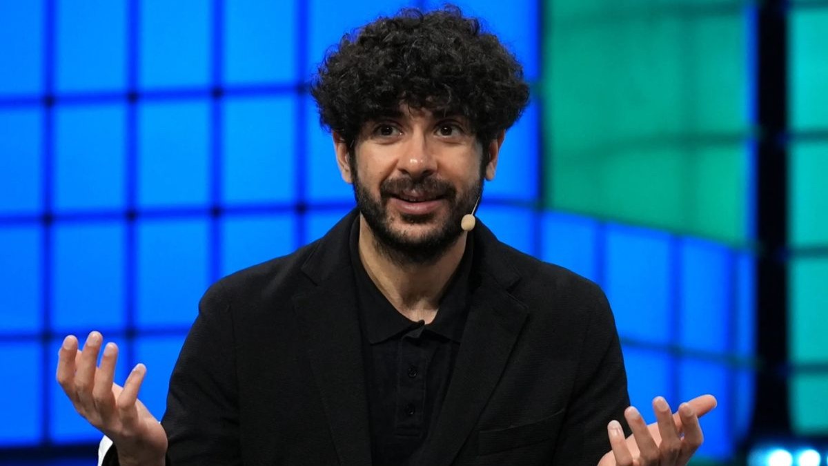 Tony Khan with hands raised